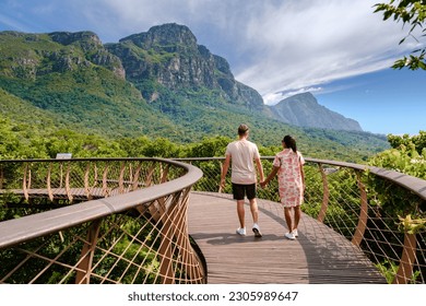couple of men and women walking at the boomslang walkway in the Kirstenbosch botanical garden in Cape Town, Canopy bridge at Kirstenbosch Gardens in Cape Town, built above lush foliage South Africa