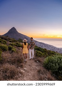 A couple of men and women watching the sunset at Lion's Head near Table Mountain Cape Town South Africa