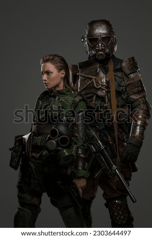 Couple of military female and male soldiers dressed in protective uniform.