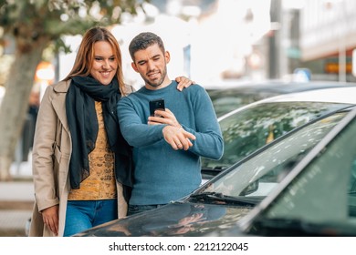 couple with mobile phone looking at cars to buy, buy car - Shutterstock ID 2212122045