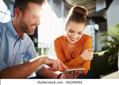 Couple in modern cafe enjoying time together browsing phone - Powered by Shutterstock