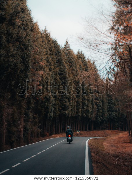 \
couple with motorbike on the\
road