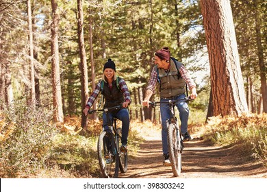 Couple Mountain Biking Through Forest, Close Up