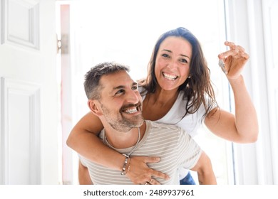 A couple move into the home at new home. Relocation, moving to new home concept - Powered by Shutterstock