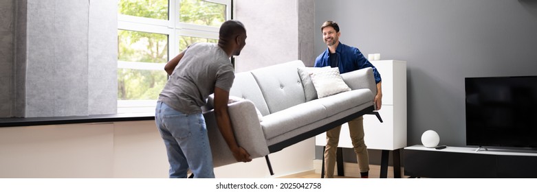 Couple Moving Furniture In Living Room. Carrying Sofa - Powered by Shutterstock