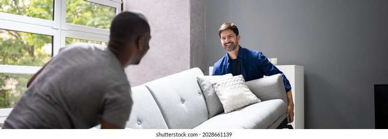 Couple Moving Furniture In Living Room. Carrying Sofa - Powered by Shutterstock