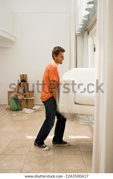 Couple Moving New Home Carrying Sofa Royalty Free Stock Image