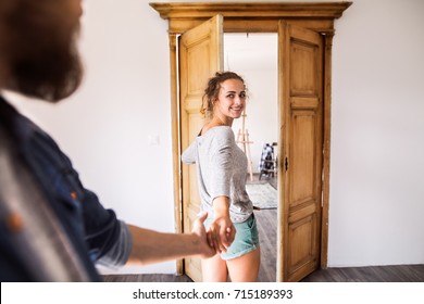 Couple Moving In New House, Entering Through The Door.