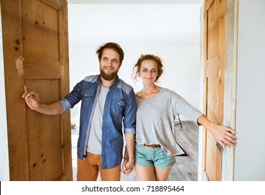 Couple Moving In New House, Entering Through The Door.