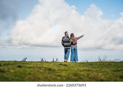 Couple in nature, with a clear blue sky as the background
