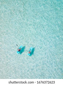 Couple Navigating In Kayak The Bacalar Lagoon, Near Cancun In Riviera Maya, Mexico