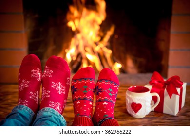 Couple near fireplace. Valentine's day at home. Winter holiday concept