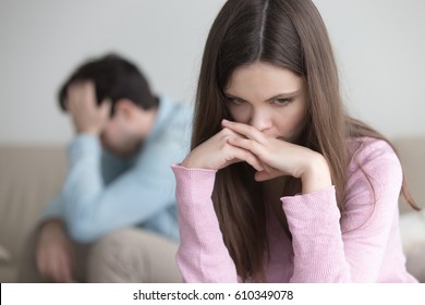 Couple not talking after a dispute, teens troubled with unwilling pregnancy. Pensive sad woman feeling guilty, upset man sitting apart. Anxious worried girl thinking over problems in relationships 