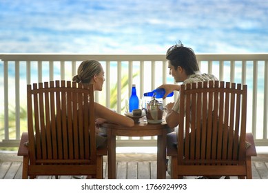 Couple On Balcony Near Beach