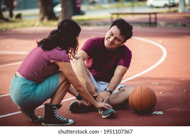 Couple On Basketball Court. Injury.