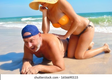 Couple On The Beach. Honeymoon. Lovers Couple At The Resort. The Unequal Marriage