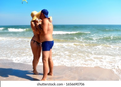 Couple On The Beach. Honeymoon. Lovers Couple At The Resort. The Unequal Marriage