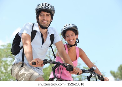 Couple On Bicycle Helmet