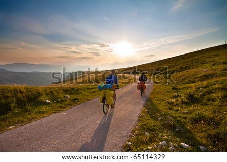 Couple on bicycles on mountain road