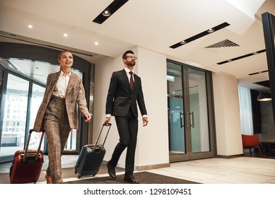 Couple On A Business Trip Doing Check-in At The Hotel