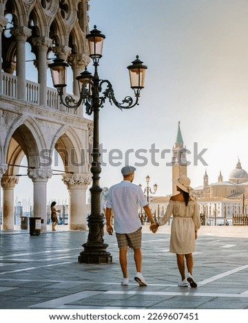 couple on a city trip in Venice, view of piazza San Marco, Doge's Palace Palazzo Ducale in Venice, Asian women and caucasian men on city trip in Venice