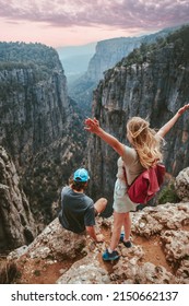 Couple on cliff Tazi canyon travel hiking together healthy lifestyle active summer vacations outdoor young man and woman tourists enjoying aerial view exploring Turkey