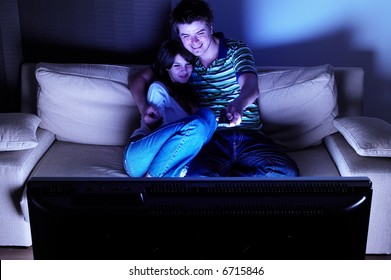 Couple On Couch Watching TV - Having A Great Time