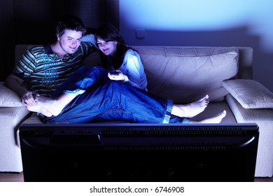 Couple On Couch Watching TV - Having A Great Time