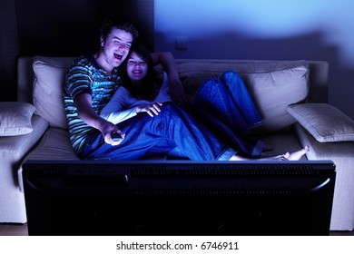 Couple On Couch Watching TV - Having A Great Time