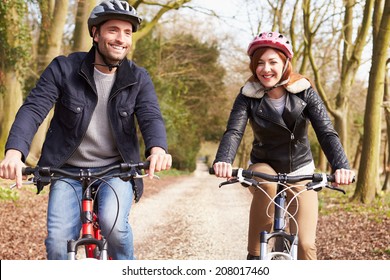 Couple On Cycle Ride In Winter Countryside