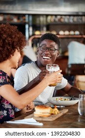 Couple On Date Meeting For Drinks And Food Making A Toast In Restaurant