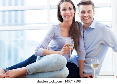 Couple On Floor Drinking Wine