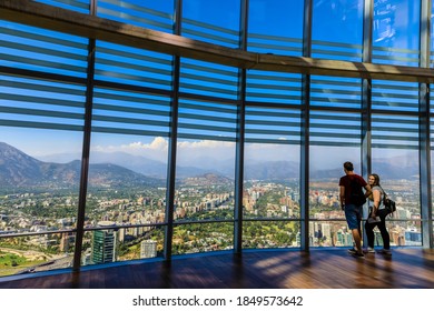 Couple on the open viewing deck at the Sky Costanera, Gran Torre Santiago, South America’s tallest building, a famous tourist attraction for tourists to Providencia, Santiago, Chile, 12.21.17
