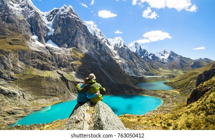 A couple on an overnight trek in the Peruvian Cordillera Huayhuash stops to admire the scenery. - Powered by Shutterstock