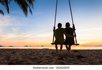 Couple on paradise beach resort sharing honeymoon - Powered by Shutterstock