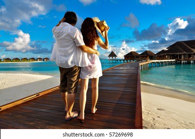 Couple On A Pathway Of Luxury Resort, Maldives