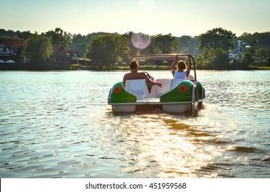 The couple on the pedal boat on the lake Jeziorak in Poland