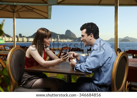 Couple on the phone looking restaurant