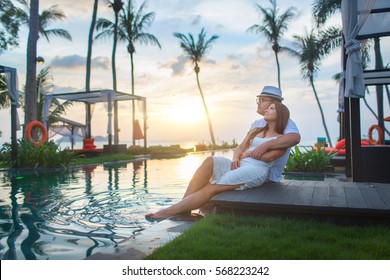 Couple On The Pool At Tropical Resort Travel Concept