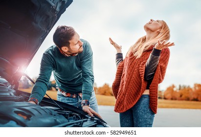 Couple On The Road Having Problem With A Car. Broken Down Car On The Road.