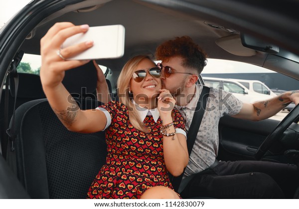 Couple On Road Trip\
Sit In Car Taking Selfie