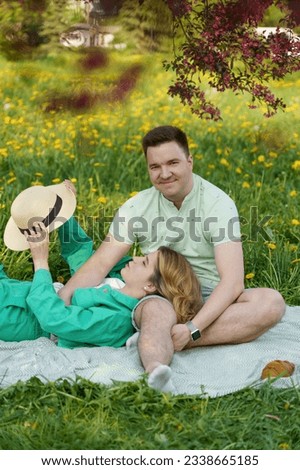 couple on romantic date, sitting on picnic blanket in blossoming park. close-up captures concept of dating, romance, creativity, mindfulness, respect, budding feelings of love and attachment.