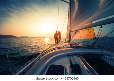 Couple On The Sailing Boat At Sunset