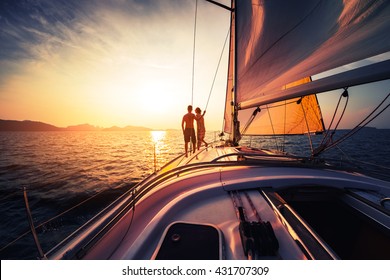 Couple On The Sailing Boat At Sunset