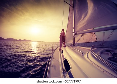 Couple On The Sailing Boat At Sunset