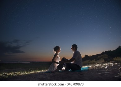 The couple on the seashore at night