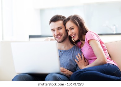 Couple On Sofa With Laptop