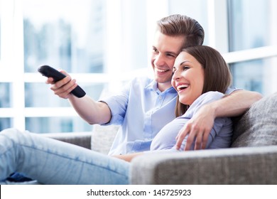 Couple On Sofa With TV Remote 