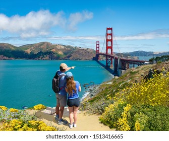 Couple On Top Of The Mountain Looking At Beautiful Summer Coastal Landscape  Friends Enjoying Time Together On Hiking Trip. Golden Gate Bridge, San Francisco, California, USA