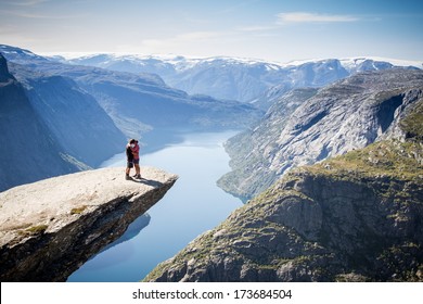 Couple On Trolltunga In Norway 